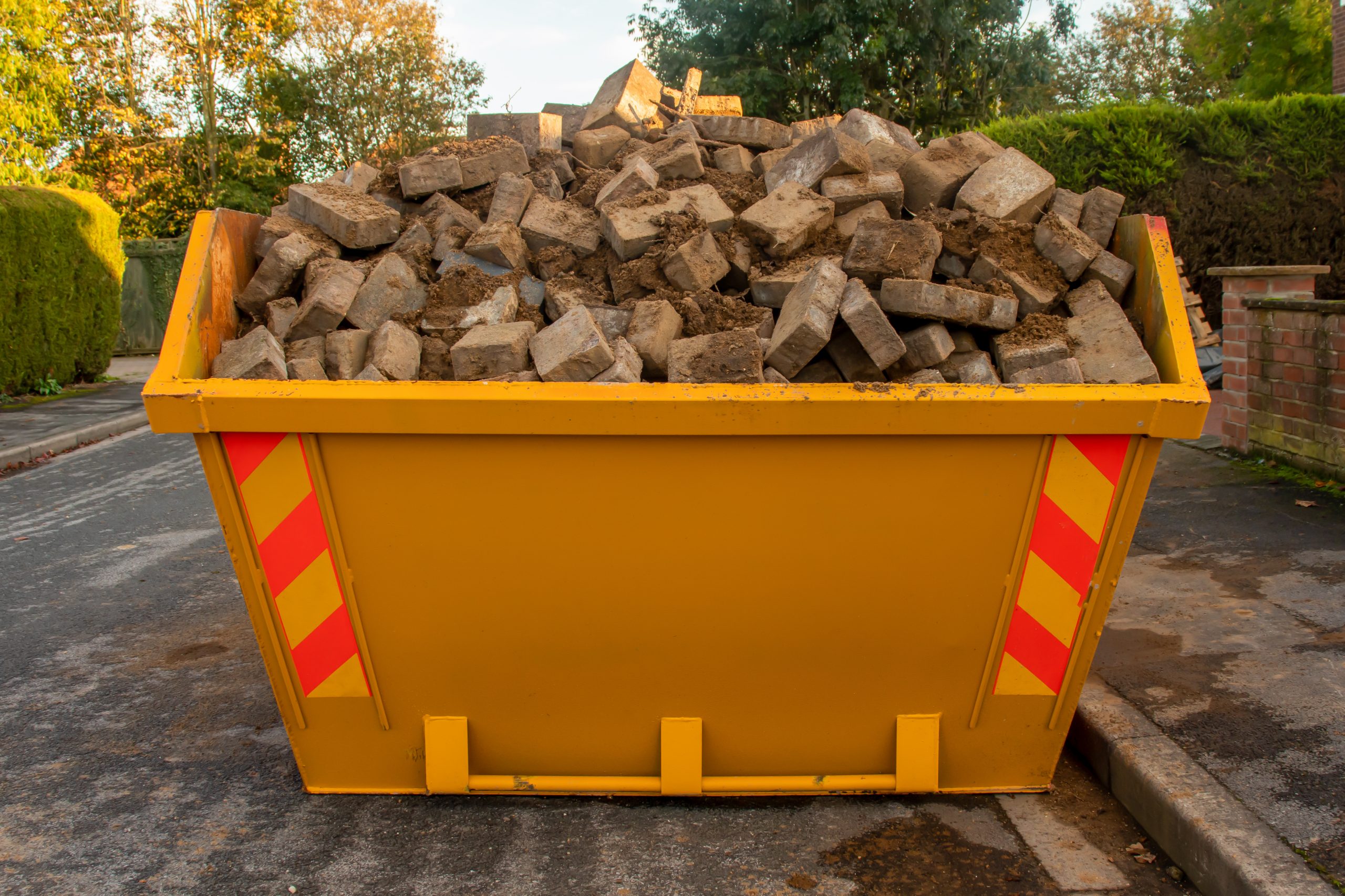 Yellow skip filled with rubble